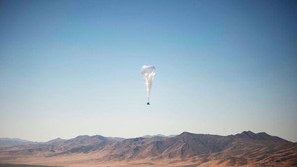 A Loon internet balloon, carrying solar-powered mobile networking equipment over the company's launch site in Winnemucca, Nevada. The balloons started delivering internet access to Kenya on Tuesday - Sputnik International