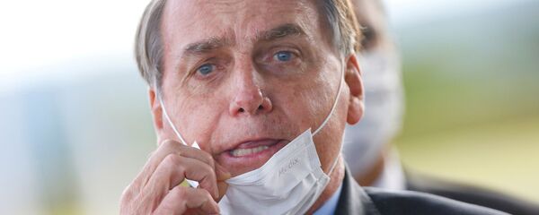 Brazil's President Jair Bolsonaro adjusts his mask as he leaves Alvorada Palace, amid the coronavirus disease (COVID-19) outbreak in Brasilia, Brazil May 13, 2020 - Sputnik International