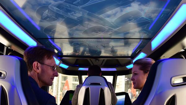Visitors sit inside the Bell Nexus concept vehicle at the Uber Elevate Summit June 12, 2019 in Washington, DC, one of the vertical takeoff and landing (VTOL) vehicles or flying cars that will be part of Uber’s fleet for aerial ride sharing. - Sputnik International