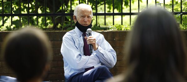 Democratic presidential candidate, former Vice President Joe Biden, center, speaks to Stacie Ritter, right, and her son, Jan, during a meeting with families who have benefited from the Affordable Care Act, Thursday, June 25, 2020 - Sputnik International