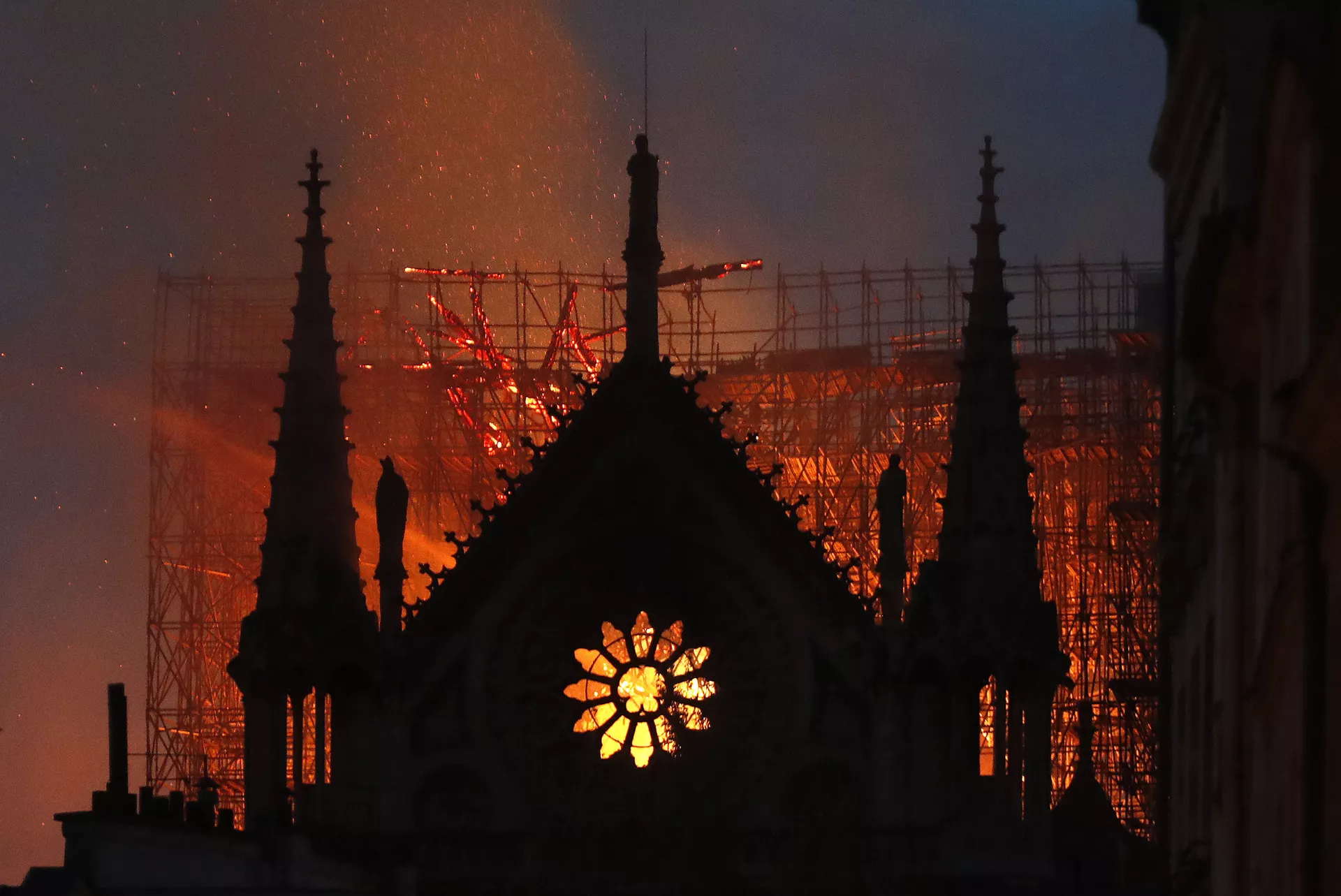 In this April 15, 2019, file photo, flames and smoke rise from Notre Dame Cathedral as it burns in Paris. The cathedral stands crippled, locked in a dangerous web of twisted metal scaffolding one year after a cataclysmic fire gutted its interior, toppled its famous spire and horrified the world. (AP Photo/Thibault Camus, File) - Sputnik International, 1920, 12.01.2025