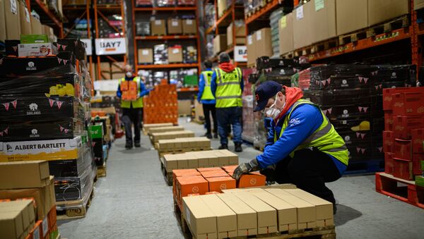 Staff for the charity 'His Church' prepare pallets of food and supplies which will be distributed to charities and community support networks across the UK from their warehouse near Market Rasen, northern England on April 14, 2020 - Sputnik International