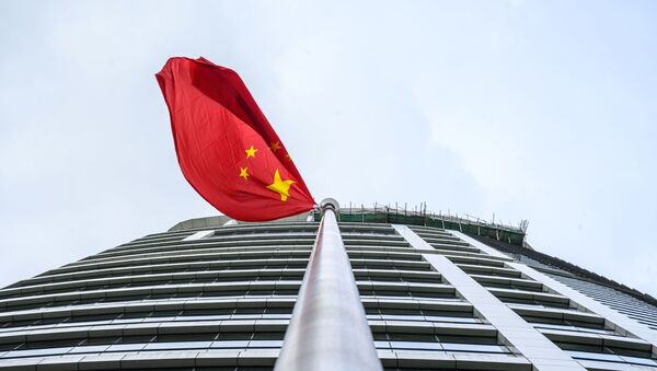 A Chinese flag flutters outside the Office for Safeguarding National Security of the Central People's Government in the Hong Kong Special Administrative Region after its official inauguration in Hong Kong on July 8, 2020 - Sputnik International