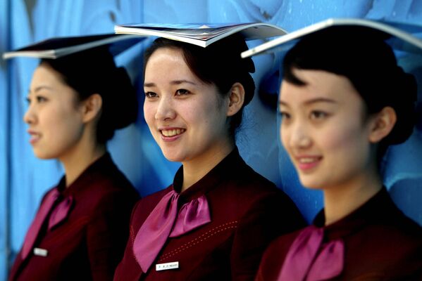 In this photo released by China's Xinhua News Agency, some stewardesses of Shenyang Taoxian International Airport receive Olympic etiquette training, Shenyang, northeast China's Liaoning Province, Thursday, April 3, 2008 - Sputnik International