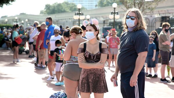 Guests wearing protective masks wait outside the Magic Kingdom theme park at Walt Disney World on the first day of reopening, in Orlando, Florida, on July 11, 2020. - Disney's flagship theme park reopened its doors to the general public on Saturday, along with Animal Kingdom, as part of their phased reopening in the wake of the Covid-19 pandemic. New safety measures have been implemented including mandatory face masks for everyone and temperature checks for guests before they enter. - Sputnik International