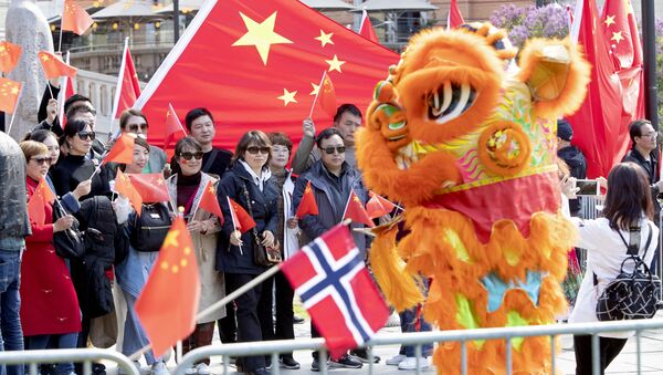 Pro China demonstrators wave flags during the visit of Li Zhanshu, Chairman of the Chinese National People's Congress Standing Committee at the Norwegian Parliament building in Oslo, on May 15, 2019 - Sputnik International
