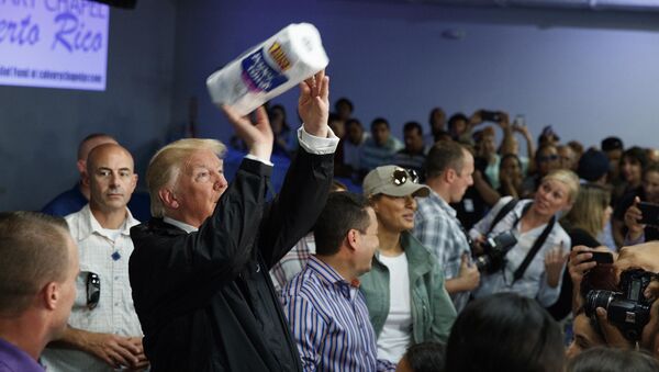 In this Tuesday, Oct. 3, 2017 photo, President Donald Trump tosses paper towels into a crowd at Calvary Chapel in Guaynabo, Puerto Rico - Sputnik International