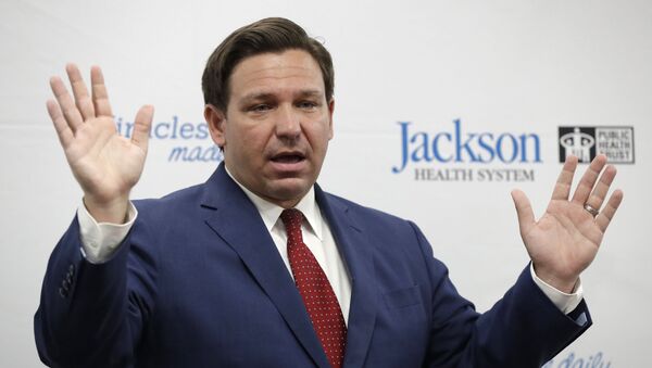 Florida Gov. Ron DeSantis gestures as he speaks during a news conference at Jackson Memorial Hospital, Monday, July 13, 2020, in Miami. DeSantis acknowledged Monday that the new coronavirus is spreading and urged people to take precautions such as wearing masks in public places, social distancing and avoiding crowds - Sputnik International