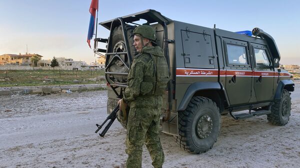 A serviceman of the Russian military police patrols the area near the town of Saraqib, liberated by the Syrian government forces, in Idlib province, Syria - Sputnik International