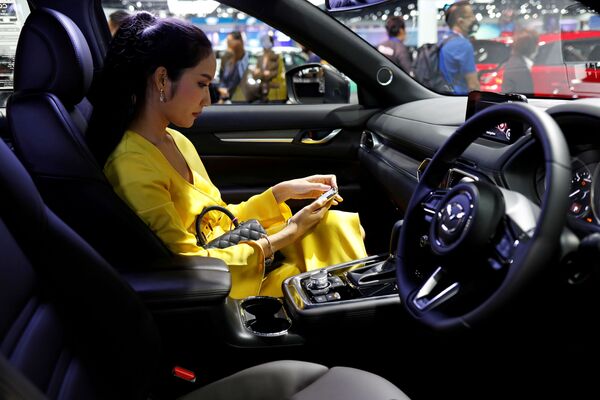 A customer sits in a Mazda CX-8 during the media day of the 41st Bangkok International Motor Show after the Thai government eased measures to prevent the spread of the coronavirus disease (COVID-19) in Bangkok, Thailand July 14, 2020. - Sputnik International