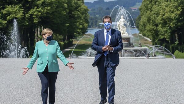 German Chancellor Angela, left, and Markus Soeder, right, Governour of the German state of Bavaria, arrive at the Herrechiemsee island, Germany, Tuesday, July 14, 2020 - Sputnik International