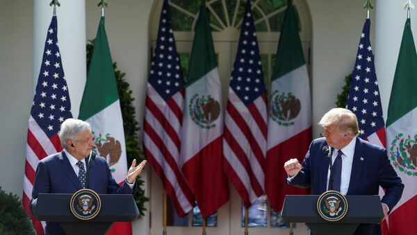 U.S. President Donald Trump listens to Mexico's President Andres Manuel Lopez Obrado as the leaders deliver individual statements prior to signing a joint declaration in the Rose Garden at the White House in Washington, U.S., July 8, 2020 - Sputnik International