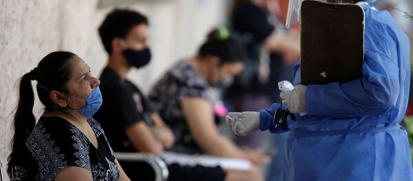 A healthcare worker talks with a woman before collecting swab samples to be tested for the coronavirus disease (COVID-19) at a public hospital, in Monterrey, Mexico July 14, 2020. A healthcare worker talks with a woman before collecting swab samples to be tested for the coronavirus disease (COVID-19) at a public hospital, in Monterrey, Mexico July 14, 2020. - Sputnik International