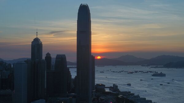 The skyline of the business district is silhouetted at sunset in Hong Kong Monday, 13 July 2020. - Sputnik International