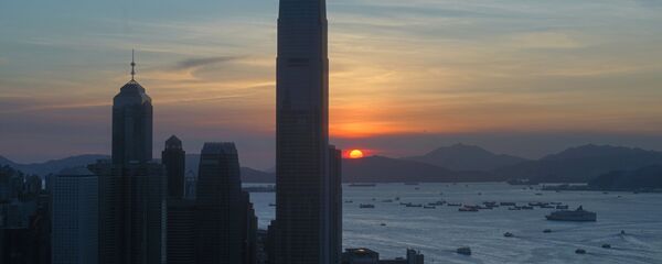 The skyline of the business district is silhouetted at sunset in Hong Kong Monday, July 13, 2020 - Sputnik International