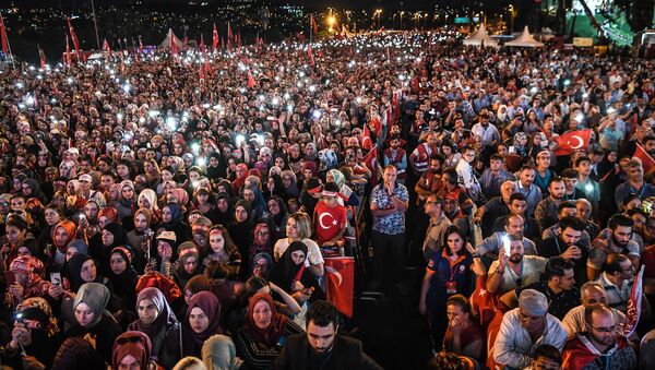 People lit lights of their mobile phones as they read the names of people killed during the July 15, 2016 coup attempt, while standing near the July 15 Martyrs Bridge (Bosphorus Bridge) in Istanbul on July 15, 2018.  - Sputnik International