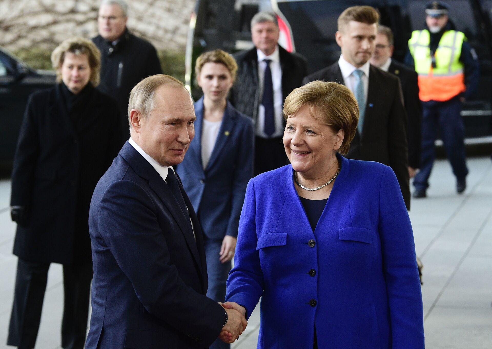 German Chancellor Angela Merkel, right, shakes hands with Russian President Vladimir Putin during arrivals for a conference on Libya at the chancellery in Berlin, Germany, Sunday, Jan. 19, 2020 - Sputnik International, 1920, 07.09.2021