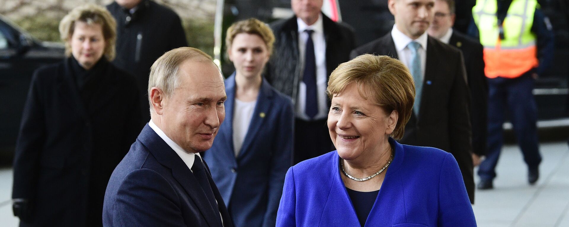 German Chancellor Angela Merkel, right, shakes hands with Russian President Vladimir Putin during arrivals for a conference on Libya at the chancellery in Berlin, Germany, Sunday, Jan. 19, 2020 - Sputnik International, 1920, 24.06.2021