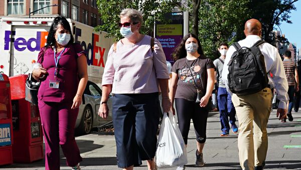 People walk while wearing protective masks as New York City moves into Phase 3 of re-opening following restrictions imposed to curb the coronavirus pandemic on July 14, 2020.  - Sputnik International