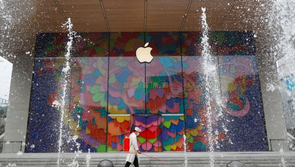 A worker sprays disinfectant outside the new Apple flagship store in Sanlitun after an outbreak of the coronavirus disease (COVID-19) in Beijing, China July 13, 2020 - Sputnik International