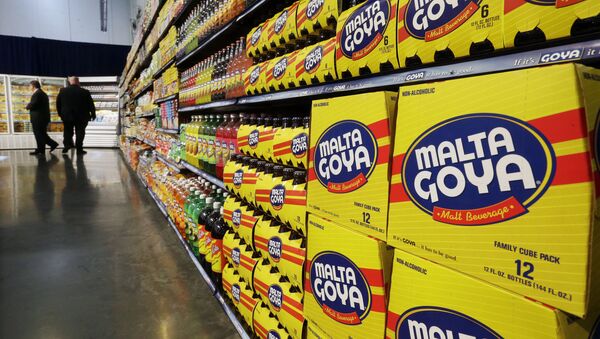 In this April 29, 2015, file photo, people walk past displays of Goya Foods products at the new corporate headquarters in Jersey City, N.J. Goya Foods is facing a a swift backlash after its CEO Robert Unanue praised President Donald Trump at White House event on Thursday, July 9, 2020 - Sputnik International