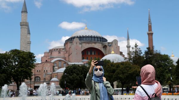 A woman poses for a selfie in front of Hagia Sophia, or Ayasofya-i Kebir Camii, which the Turkish president declared to be open to Muslim worship after a court ruling, in Istanbul, Turkey, July 11, 2020 - Sputnik International