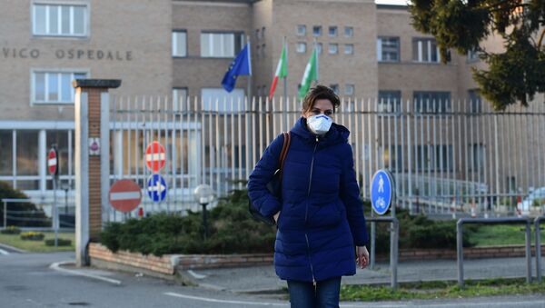 A nurse wearing a protective respiratory mask leaves the municipal hospital in Codogno, southeast of Milan, on February 22, 2020. - Sputnik International