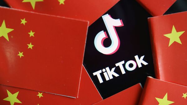 China's flags are seen near a TikTok logo in this illustration picture taken July 16, 2020 - Sputnik International
