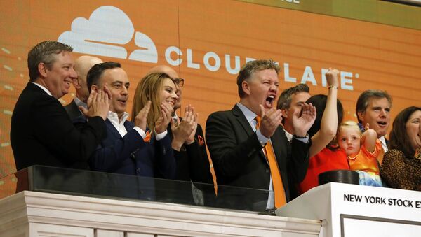  In this Sept. 13, 2019, file photo, Cloudflare co-founder and CEO Matthew Prince, right center, applauds during New York Stock Exchange opening bell ceremonies to celebrate his company's IPO. San Francisco-based Cloudflare said Wednesday, Jan. 15, 2020, it will provide free cybersecurity support to federal election campaigns. - Sputnik International
