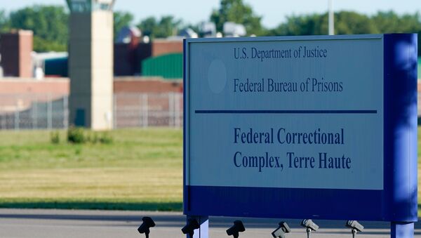 A sign stands outside the Federal Correctional Institution, Terre Haute, as Daniel Lewis Lee, convicted in the killing of three members of an Arkansas family in 1996, is set to be put to death in the first federal execution in 17 years, in Terre Haute, Indiana, U.S. July 13, 2020. - Sputnik International
