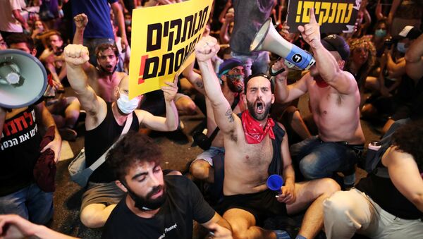 Israelis block a main junction in the city as they protest against the government's response to the financial fallout of the coronavirus disease (COVID- 19) crisis in Tel Aviv, Israel July 11, 2020 - Sputnik International