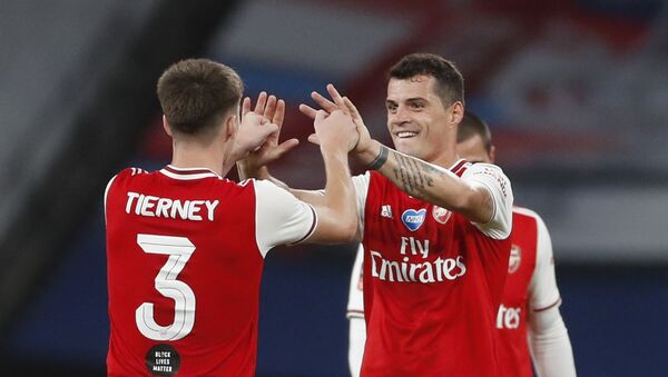 Soccer Football - FA Cup Semi Final - Arsenal v Manchester City - Wembley Stadium, London, Britain - July 18, 2020 Arsenal's Granit Xhaka and Kieran Tierney celebrate after the match, as play resumes behind closed doors following the outbreak of the coronavirus disease (COVID-19) - Sputnik International