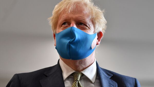 Britain's Prime Minister Boris Johnson, wearing a face mask, visits headquarters of the London Ambulance Service NHS Trust, amid the spread of the coronavirus disease (COVID-19), in London, Britain July 13, 2020 - Sputnik International