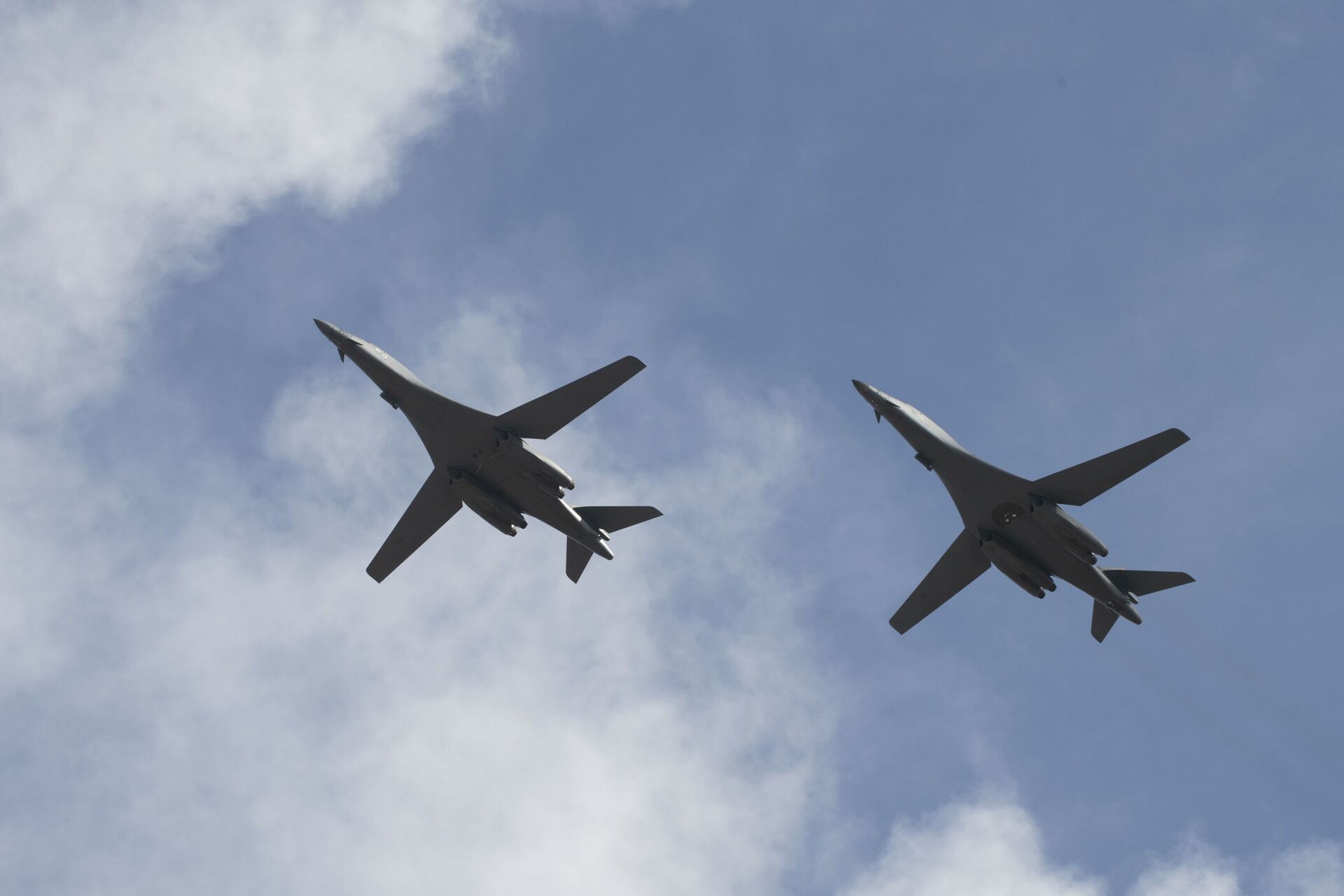 Two B-1B Lancers, assigned to the 28th Bomb Wing, Ellsworth Air Force Base, S.D., conduct a flyover before landing at Andersen AFB, Guam, July 17, 2020. The Bomber Task Force is deployed to Andersen AFB in support of Pacific Air Forces’ training efforts with allies, partners and joint forces. (U.S. Air Force Photo by Airman 1st Class Christina Bennett) - Sputnik International, 1920, 07.09.2021