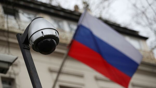 A security camera is seen, and a flag flies outside the consular section of Russia's embassy in London, Britain, March 15, 2018.  - Sputnik International