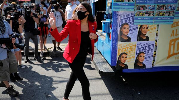 U.S. Rep. Alexandria Ocasio-Cortez (D-NY) waves as she makes a stop to greet voters during the Democratic congressional primary election in the Queens borough of New York City, New York, U.S., June 23, 2020 - Sputnik International
