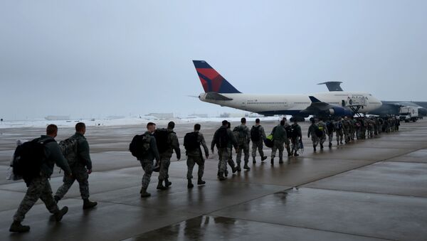 Airmen of the 388th and the 419th Fighter Wings from Hill Air Force Base, Utah prepare to board an aircraft for deployment to Osan Air Force Base, South Korea, Jan. 11, 2014. The 388th and 419th airmen will deploy as part of a Theater Security Package (TSP) to assist with supporting and defending the South Korean border with North Korea. (U.S. Air Force photo by Senior Airman Justyn M. Freeman/Released) - Sputnik International