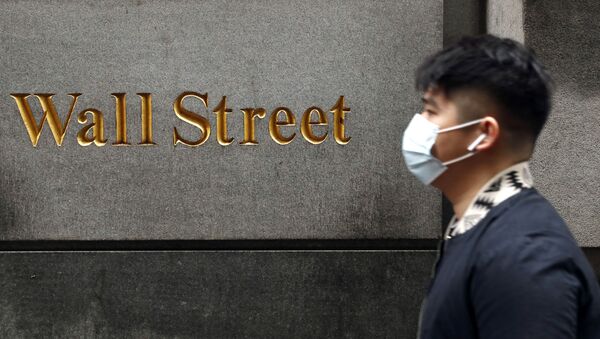 A man wears a protective mask as he walks on Wall Street during the coronavirus outbreak in New York City, New York, U.S., March 13, 2020 - Sputnik International
