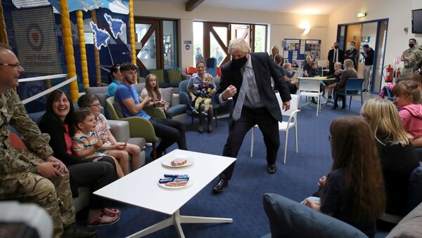 Britain's Prime Minister Boris Johnson reacts as he visits families in the community centre at RAF Lossiemouth, during a visit to the Highlands and Northern Isles of Scotland, in Moray, Scotland, Britain July 23, 2020 - Sputnik International