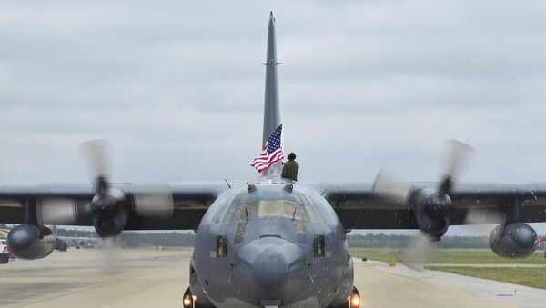 Tech. Sgt. Bruce Ramos, a 1st Special Operations Group Detachment 1 radio operator, raises an American flag from an MC-130P Combat Shadow while it taxis at Hurlburt Field, Fla., May 15, 2015.  - Sputnik International