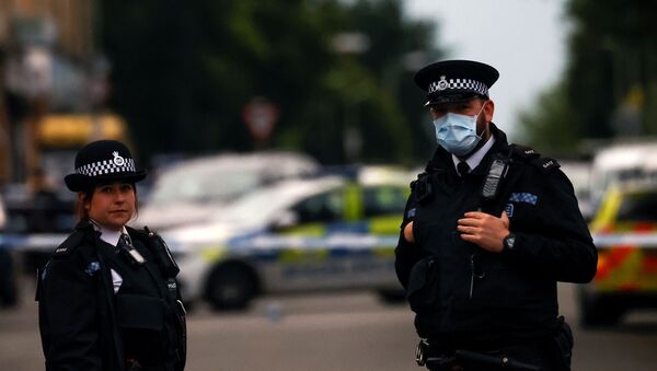 Police officers stand at the scene in Toxteth after the shooting of a woman, in Liverpool, Britain, July 9, 2020 - Sputnik International