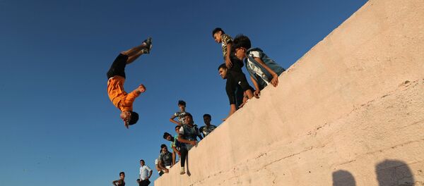 A Palestinian youth demonstrates his parkour skills on a beach as the coronavirus disease (COVID-19) restrictions ease in Gaza City July 10, 2020 A Palestinian youth demonstrates his parkour skills on a beach as the coronavirus disease (COVID-19) restrictions ease in Gaza City July 10, 2020 - Sputnik International