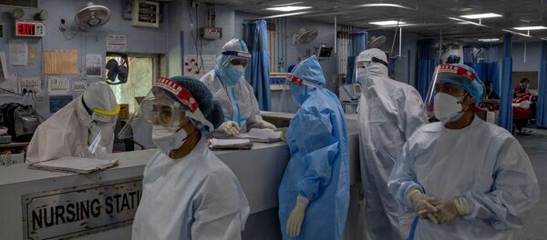 Medical workers wearing personal protective equipment (PPE) are seen inside an Intensive Care Unit (ICU) for patients suffering from the coronavirus disease - Sputnik International