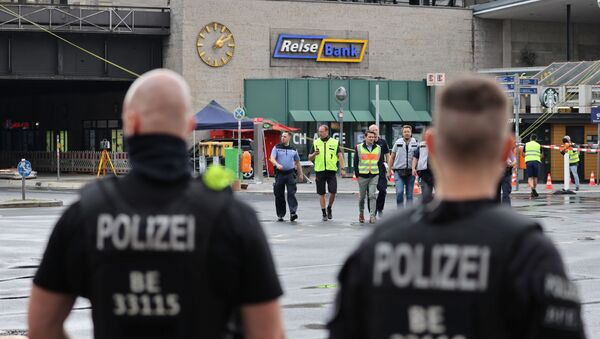 Officials walk past a car which crashed into a group of seven people at Bahnhof Zoo train station in Berlin - Sputnik International