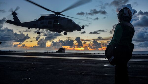 An MH-60R Sea Hawk helicopter launches during flight operations aboard the U.S. Navy aircraft carrier USS Ronald Reagan in the South China Sea July 17, 2020 - Sputnik International