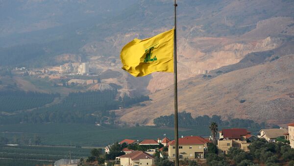 A Hezbollah flag flutters in the southern Lebanese village of Khiam, near the border with Israel, Lebanon July 28, 2020 - Sputnik International