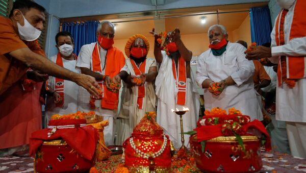 Hindu priests and supporters of the Vishva Hindu Parishad (VHP), a Hindu nationalist organisation, perform rituals next to pots filled with holy water and soil which they brought from various Hindu religious places, before taking the pots to the northern town of Ayodhya for a stone laying ceremony in the Ram Temple, in Ahmedabad, India July 27, 2020 - Sputnik International