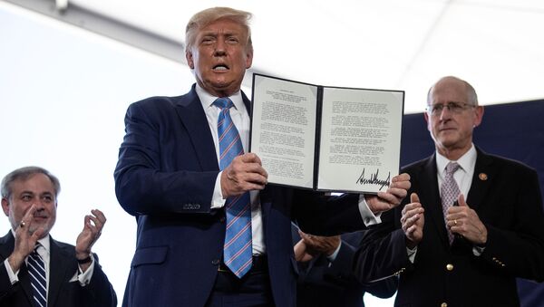 U.S. President Donald Trump is applauded as he displays a presidential permit for energy development that he signed during a tour of the Double Eagle Energy Oil Rig in Midland, Texas, U.S., July 29, 2020. - Sputnik International
