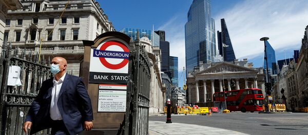 A man wearing a face mask and suit exits Bank underground station, in front of the Bank of England and Royal Exchange Building, amid the coronavirus disease (COVID-19) outbreak, in London, Britain, July 30, 2020. A man wearing a face mask and suit exits Bank underground station, in front of the Bank of England and Royal Exchange Building, amid the coronavirus disease (COVID-19) outbreak, in London, Britain, July 30, 2020. - Sputnik International