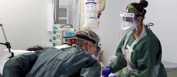 Nurses care for a patient in an Intensive Care ward treating victims of the coronavirus disease (COVID-19) in Frimley Park Hospital in Surrey, Britain, May 22, 2020 - Sputnik International